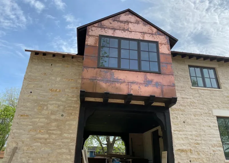 Copper metal panel facade on a stone building for Skylight Installation in West Linn